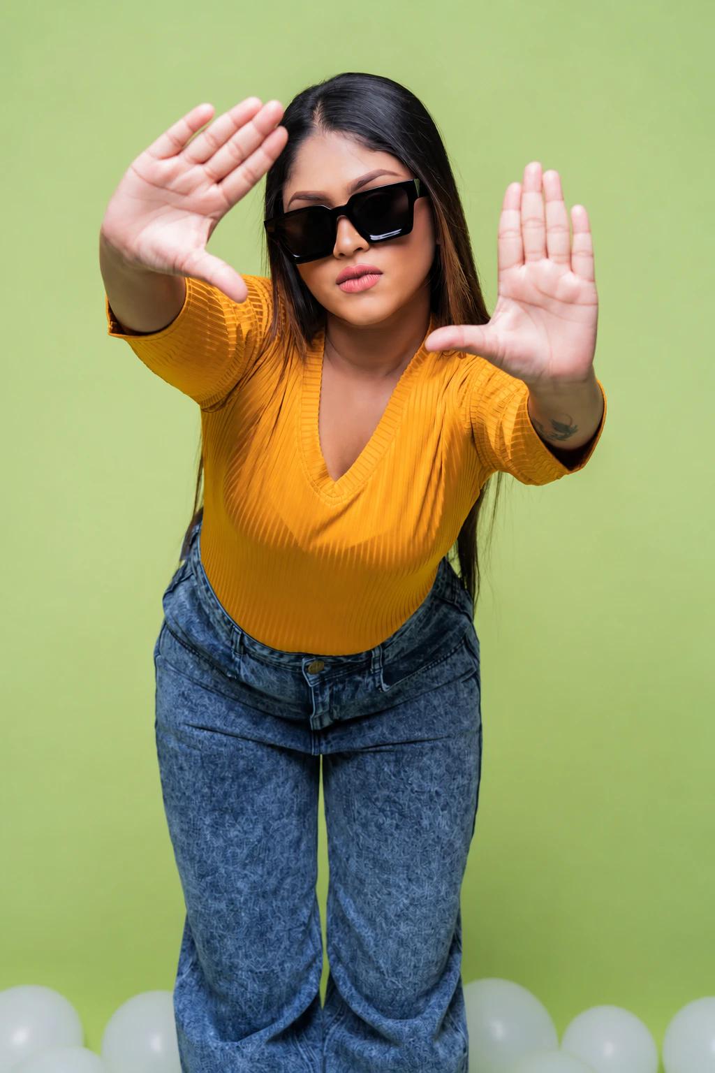 Playful fashion portrait against a soft green backdrop